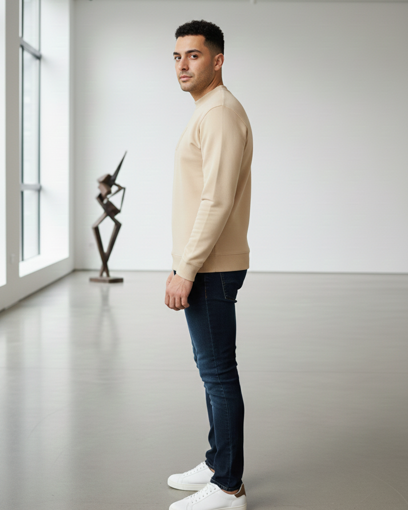 Man standing in a modern room with a sculpture in the background
