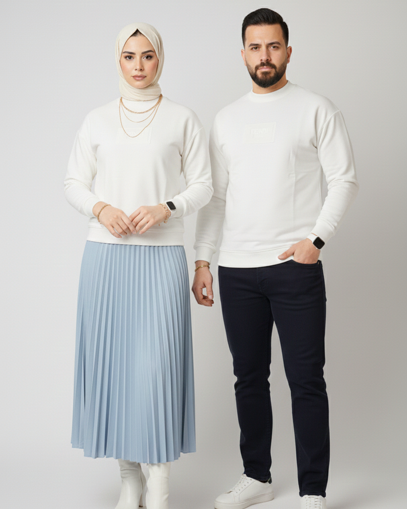 Two people wearing white tops and dark pants on a plain background